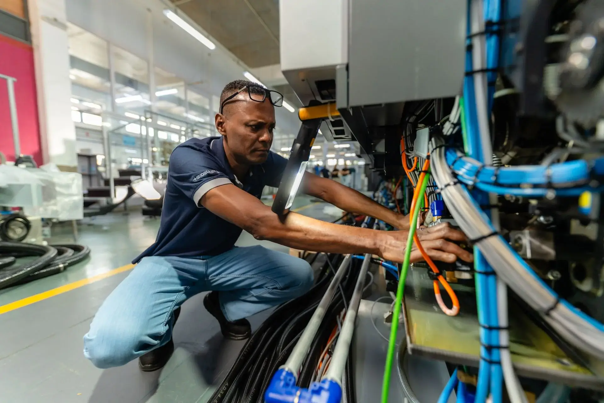 Technician servicing a printing press