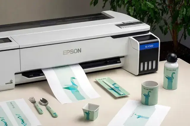 Epson SureColor SC-F500 sublimation printer with sublimated mugs and fabric