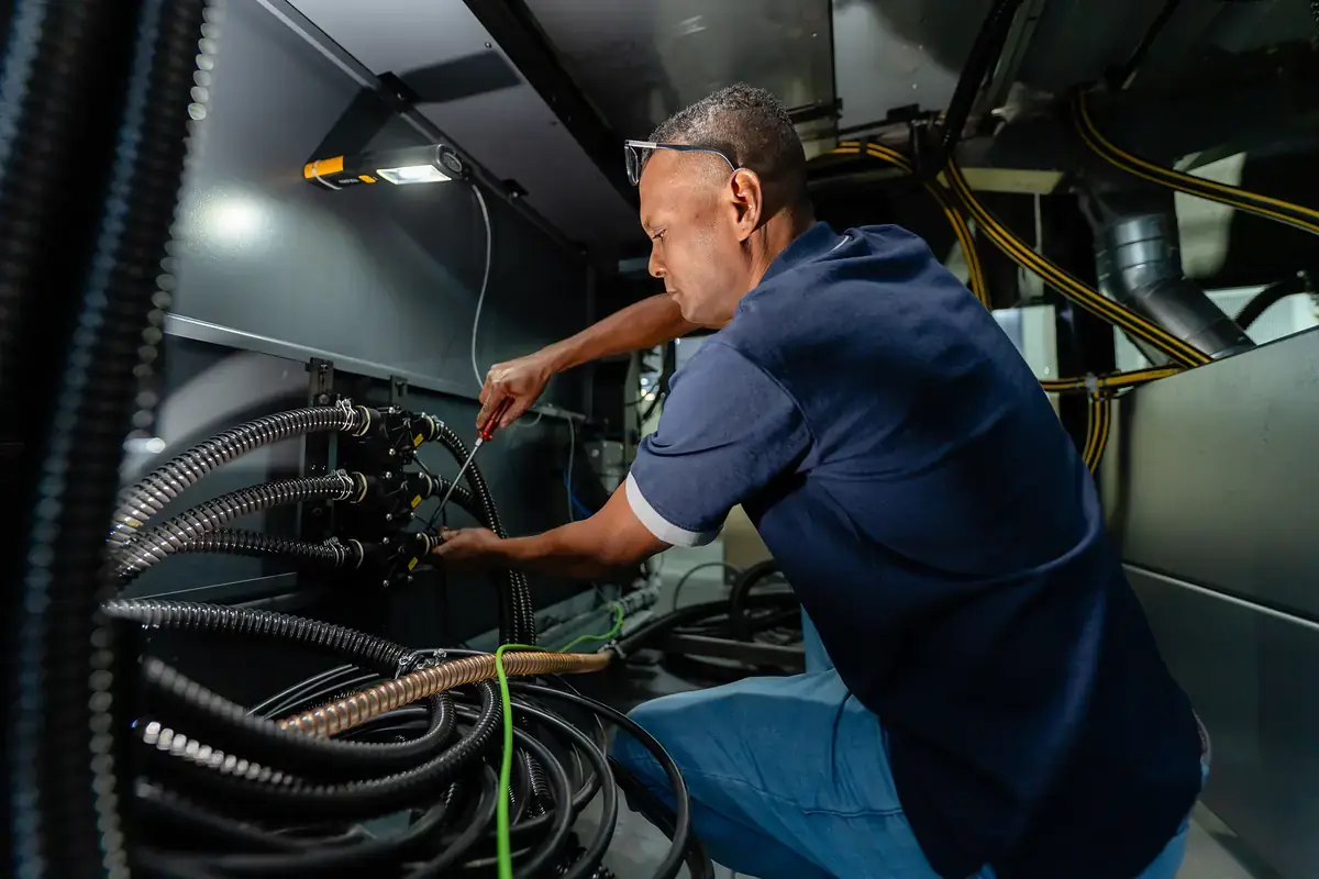 Intergraph technician servicing a printing machine